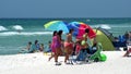 Tourists with shade umbrellas on the beach