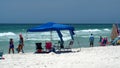 Tourists with shade umbrellas on the beach