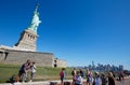 Tourists shooting selfies and walking near Statue of Liberty, New York