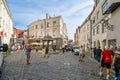 Tourists shop and sightsee as they pass by the famous Cat`s Well in the Old Town section of the medieval city of Tallinn, Estonia