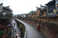 Tourists, shops and ancient houses by the wall in Phoenix Town, China