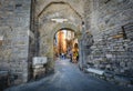 Tourists sight-see and shop inside the ancient town gate of the coastal village of Porto Venere, on the Ligurian coast of Italy Royalty Free Stock Photo