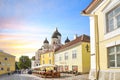 Tourists sightsee and enjoy lunch at a sidewalk cafe on Toompea Hill alongside the Russian Orthodox Cathedral in Tallinn Estonia.