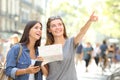 Tourists sightseeing holding a map and pointing up