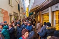 Crowds of tourists at narrow commercial street Venice canal Italy