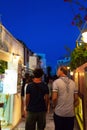 Tourists sightseeing on night streets of Oia town Santorini Greece