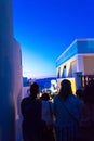 Tourists sightseeing on night streets of Oia town Santorini Greece