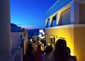 Tourists sightseeing on night streets of Oia town Santorini Greece