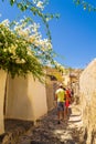 Tourists sightseeing at old abondened streets Santorini Greece