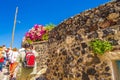 Tourists sightseeing at old abondened streets Santorini Greece