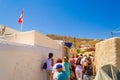 Tourists sightseeing at old abondened streets Santorini Greece