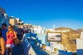 Tourists sightseeing on picturesque Oia town streets Santorini island Royalty Free Stock Photo