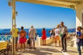 Tourists sightseeing on terrace with beautiful ocean view at Santorini Greece Royalty Free Stock Photo