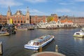 Tourists sightseeng at Canal Boats next tot Central Station of Amsterdam