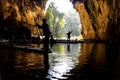 Tourists in silhouette ferried on bamboo rafts inside the tunnel river within Tham Nam Lod caves, Mae Hong Son province