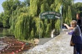 Tourists on Silver Street Bridge looking at the Punts moored on the River Cam