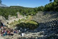 Tourists sit amongst the ruins of the theatre at Phaselis in Turkey. Royalty Free Stock Photo