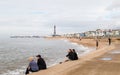 Tourists sit on Blackpool seafront Royalty Free Stock Photo