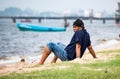 Tourists sit and relax on Krating Lai Beach, Chonburi Province, Thailand