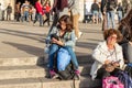 Tourists sit on the steps in front of the Cathedral of Milan - Duomo di Milano in Milan city, Italy Royalty Free Stock Photo