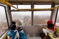 Tourists sit in Usuzan Ropeway for going down from Mount Usu in winter in Hokkaido, Japan