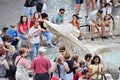 Tourists sitting around the Fountain of the Boat below the Spanish Steps Royalty Free Stock Photo