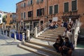 Tourists sitting on a bridge in Venice, Itlay Royalty Free Stock Photo
