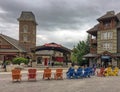 Tourists sitting in colorful wooden recliners in Blue Mountain Village Canadian popular resort in summer