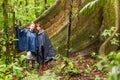 Tourists Sitting Next To A Huge Ceiba Tree Amazon