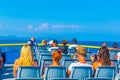 Tourists sitting on an upper deck of a ferry travelling from Saint Tropez to Saint Raphael in France Royalty Free Stock Photo