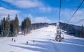 Tourists on the ski slopes and a modern chair lift. Otdih in the ski resort Bukovel Royalty Free Stock Photo