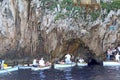 Tourists in small boats waiting to enter the Blue Grotto on Capri