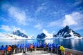 Stunning Lemaire Channel, Antarctica, tourists watching entry in channel filled with ice between mountains, Antarctic Peninsula Royalty Free Stock Photo