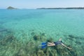 Tourists snorkel in crystal turquoise water near tropical resort in Phuket, Thailand. Summer, Vacation, Travel and Holiday concept Royalty Free Stock Photo