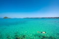 Tourists snorkel in crystal turquoise water near tropical resort in Phuket, Thailand. Summer, Vacation, Travel and Holiday concept