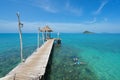 Tourists snorkel in crystal turquoise water near tropical resort Royalty Free Stock Photo