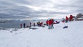 Tourists on snow covered slopes in Antarctica Royalty Free Stock Photo