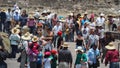 Tourists and souvenir vendors walk at Teotihuacan, many wearing sombreros