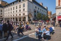 Tourists spending leisure time in townsquare of city during sunny day