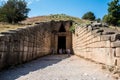 Tourists stainding at the entrance of Treasury of Atreus, Peloponnese, Greece. Royalty Free Stock Photo