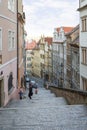 Tourists, stairs and old buildings in Prague