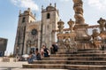 Tourists on stairs of Pillory of Porto against Se cathedral, Portugal