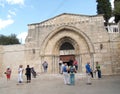 Tourists stand at an entrance to church of the Dormition of the