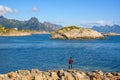 Tourists stand on the rocks to see the great natural panoramic view at Kabelvaag In the Lofoten Islands