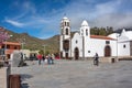 Tourists stand on the square near the church Iglesia de San Fernando Rey 1679.