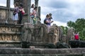 Tourists stand on the stairway of the Vatadage which forms part of the Quadrangle at the ancient Sri Lankan capital at Royalty Free Stock Photo