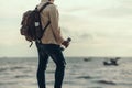 Tourists stand to watch sea sunset. backpacker, travel concept