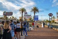 Tourists standing at entrance sign while photographer photographing couple