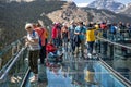 Tourists standing on the glass floored observation deck of the Columbia Icefield Skywalk in Jasper National Park, Alberta, Canada