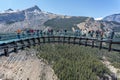 Tourists standing on the glass floored observation deck of the Columbia Icefield Skywalk in Jasper National Park, Alberta, Canada